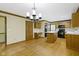 Open kitchen with wood cabinets, center island, and hardwood floors extends into dining room at 960 Arrowwood Dr, Carmel, IN 46033