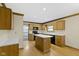 Spacious kitchen with wood cabinets, an island, and a view to a dining area at 960 Arrowwood Dr, Carmel, IN 46033
