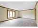 Bright, carpeted living room featuring wood trim and a bay window at 960 Arrowwood Dr, Carmel, IN 46033