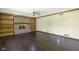 Spacious living room with a brick fireplace, built-in shelving and dark, glossy hardwood floors at 960 Arrowwood Dr, Carmel, IN 46033