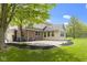 Back exterior view of a brick two-story home with a brick patio and green lawn at 960 Arrowwood Dr, Carmel, IN 46033