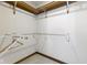 Organized walk-in closet with wooden shelving and a hanging rod at 960 Arrowwood Dr, Carmel, IN 46033