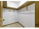Spacious walk-in closet with wooden shelving and carpeted floor at 960 Arrowwood Dr, Carmel, IN 46033