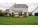Backyard featuring a wood deck and lush lawn, perfect for outdoor entertaining and relaxation at 10691 Morristown Ct, Carmel, IN 46032