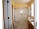 Bright bathroom featuring a shower/tub combo with sliding doors and a wooden vanity at 10691 Morristown Ct, Carmel, IN 46032
