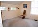 Bedroom features three bright windows, neutral walls and carpet, and is furnished with a chair at 10691 Morristown Ct, Carmel, IN 46032
