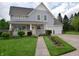 Inviting two-story home featuring a covered front porch, a well-manicured lawn, and an attached two-car garage at 10691 Morristown Ct, Carmel, IN 46032
