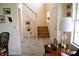 Inviting foyer with staircase, tile flooring, and decorative furnishings for a warm welcome at 10691 Morristown Ct, Carmel, IN 46032