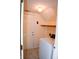 Cozy laundry room featuring tile flooring, washer, exterior door, and convenient overhead shelving at 10691 Morristown Ct, Carmel, IN 46032