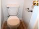 Close-up of a white toilet and toilet paper holder in a clean and functional bathroom at 10691 Morristown Ct, Carmel, IN 46032