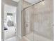 Modern bathroom featuring tiled shower with sliding glass doors and neutral color palette at 10818 Soda Creek Ct, Indianapolis, IN 46239