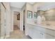 Elegant bathroom with double sinks, white cabinetry, and a glass-enclosed shower at 10818 Soda Creek Ct, Indianapolis, IN 46239
