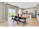 Dining room with wooden table and view to kitchen and outside patio, creating an inviting atmosphere at 10818 Soda Creek Ct, Indianapolis, IN 46239