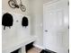 Mudroom entry featuring a bench with storage, hooks, and a decorative bicycle accent at 10818 Soda Creek Ct, Indianapolis, IN 46239