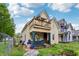 Two-story home featuring a second-floor balcony, complemented by a cozy front porch at 1121 Eugene St, Indianapolis, IN 46208