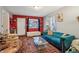Stylish living room featuring vibrant red accent wall, plush blue sofa, and unique decor at 1121 Eugene St, Indianapolis, IN 46208