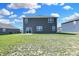 View of the home's siding and backyard featuring a sliding glass door and an expansive lawn at 113 Hunter'S Rdg Dr, Danville, IN 46122
