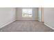 Bright bedroom featuring plush carpet, neutral walls, and a sun-filled window at 113 Hunter'S Rdg Dr, Danville, IN 46122