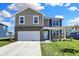 Two-story home with brick and siding, features a two-car garage, manicured lawn, and tasteful landscaping at 113 Hunter'S Rdg Dr, Danville, IN 46122