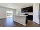 Modern kitchen featuring dark cabinets, an island with a sink, and stainless steel appliances at 113 Hunter'S Rdg Dr, Danville, IN 46122