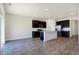 Modern kitchen with a central island, dark cabinets, stainless appliances, and plenty of counter space at 113 Hunter'S Rdg Dr, Danville, IN 46122