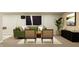 Modern living room with green sofa, decorative artwork, stylish chairs and lots of natural light at 11528 Aubrey Ln, Fishers, IN 46040