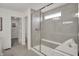 Modern bathroom with a glass-enclosed shower, a built-in bench, and a nearby walk-in closet at 11612 Aubrey Ln, Fishers, IN 46040