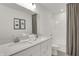 Elegant bathroom featuring double sinks, a quartz countertop, and a shower-tub combination with modern fixtures at 11612 Aubrey Ln, Fishers, IN 46040