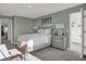 Serene bedroom featuring green walls, natural light, and comfortable sleeping quarters at 11612 Aubrey Ln, Fishers, IN 46040