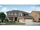 Charming two-story home boasts brick accents, a three-car garage, and a welcoming front yard at 11612 Aubrey Ln, Fishers, IN 46040