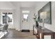 Inviting foyer with wood floors, white trim, console table, and modern decor at 11612 Aubrey Ln, Fishers, IN 46040