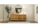 A stylish entry with a geometric wood console, round mirror, and decorative accents at 11641 Aubrey Ln, Fishers, IN 46040