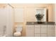 Neutral toned bathroom featuring double sink vanity and shower with curtain at 11682 Aubrey Ln, Fishers, IN 46040
