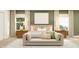 A bright bedroom features a large cozy bed, decorative pillows, bedside lamps, and stylish wall art at 11682 Aubrey Ln, Fishers, IN 46040