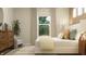 Bright bedroom features a large window, cozy bed, decorative pillows, and modern furniture creating a relaxing space at 11682 Aubrey Ln, Fishers, IN 46040