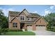 A charming two-story home with a brick and siding facade and an attached two-car garage at 11682 Aubrey Ln, Fishers, IN 46040