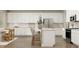Bright kitchen with white cabinets, a center island with seating, and stainless steel appliances at 11682 Aubrey Ln, Fishers, IN 46040