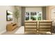 Bright living room with large window, sleek TV, wooden console and modern neutral-colored furniture at 11682 Aubrey Ln, Fishers, IN 46040