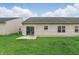 Spacious backyard showcasing green lawn, patio, and vinyl siding at 11716 Whisper Cove Dr, Fishers, IN 46037