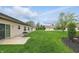 Lush backyard with patio, surrounded by well-manicured lawns and beautiful landscaping at 11716 Whisper Cove Dr, Fishers, IN 46037