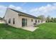 Well-maintained backyard featuring a patio, green lawn, and vinyl siding at 11716 Whisper Cove Dr, Fishers, IN 46037