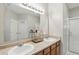Bathroom featuring double sinks and an enclosed glass shower at 11716 Whisper Cove Dr, Fishers, IN 46037