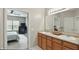 Bathroom with double sinks and view into bedroom at 11716 Whisper Cove Dr, Fishers, IN 46037