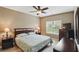 Bright bedroom featuring a ceiling fan, plush bedding, and coordinating bedside lamps at 11716 Whisper Cove Dr, Fishers, IN 46037
