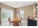 Bright dining room with a wooden table set, sliding glass doors, and neutral décor at 11716 Whisper Cove Dr, Fishers, IN 46037