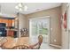 Inviting dining area featuring a wooden table, sliding glass doors, and seamless access to the kitchen at 11716 Whisper Cove Dr, Fishers, IN 46037