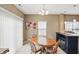 Cozy dining area features a wooden table, neutral walls, and natural light from sliding glass doors at 11716 Whisper Cove Dr, Fishers, IN 46037