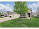 Charming home exterior with a well-maintained lawn, brick accents, and attached two-car garage at 11716 Whisper Cove Dr, Fishers, IN 46037