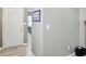 Hallway featuring neutral paint, light-colored vinyl flooring, and a view into the bedroom at 11716 Whisper Cove Dr, Fishers, IN 46037