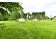 Large grassy backyard with a detached garage and storage shed at 12087 N Gasburg Rd, Mooresville, IN 46158